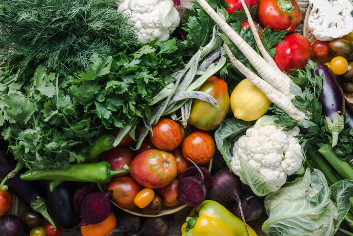 Variety of colorful food displayed such as orange, white, green, red and more. 