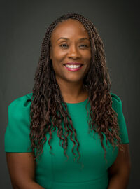 RoWandalla D. Goudeau, DrPH, CHES wearing green shirt in front of gray screen