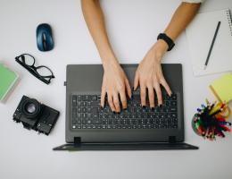 women typing on a laptop