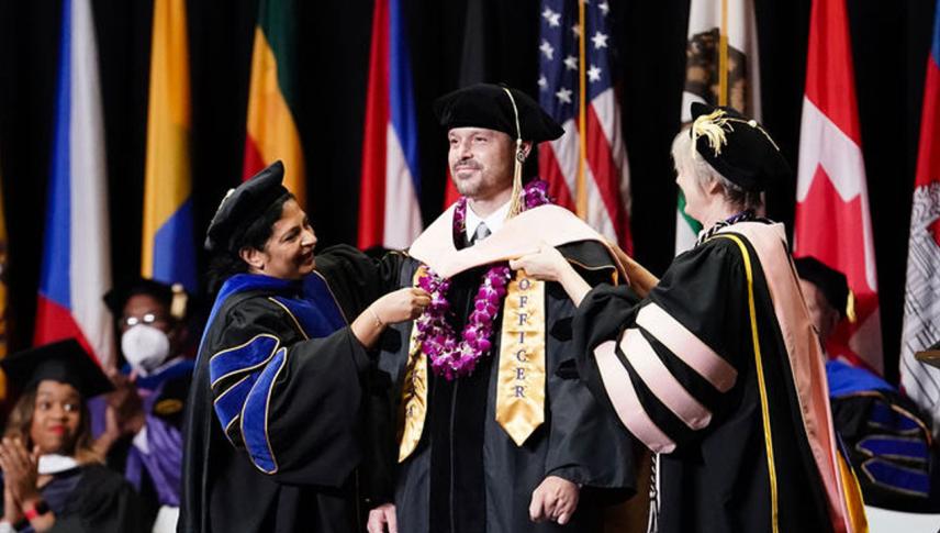 graduate male receiving honors