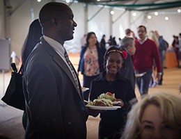 Man with food plate in hand smiling